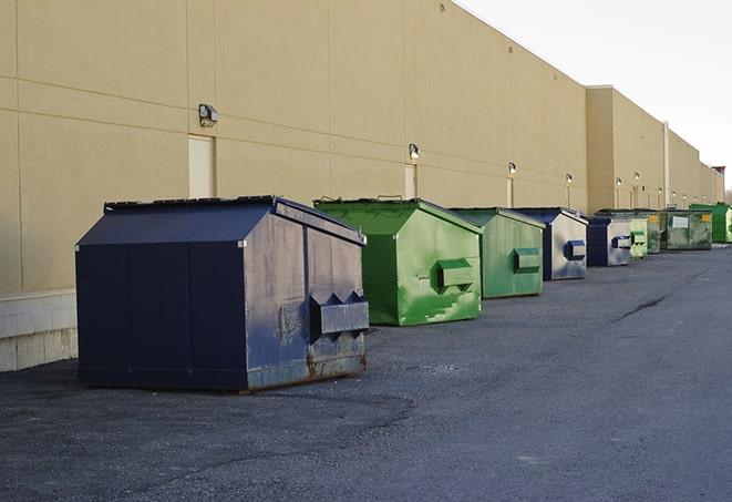 a truck unloading construction waste into a dumpster in Coconut Creek